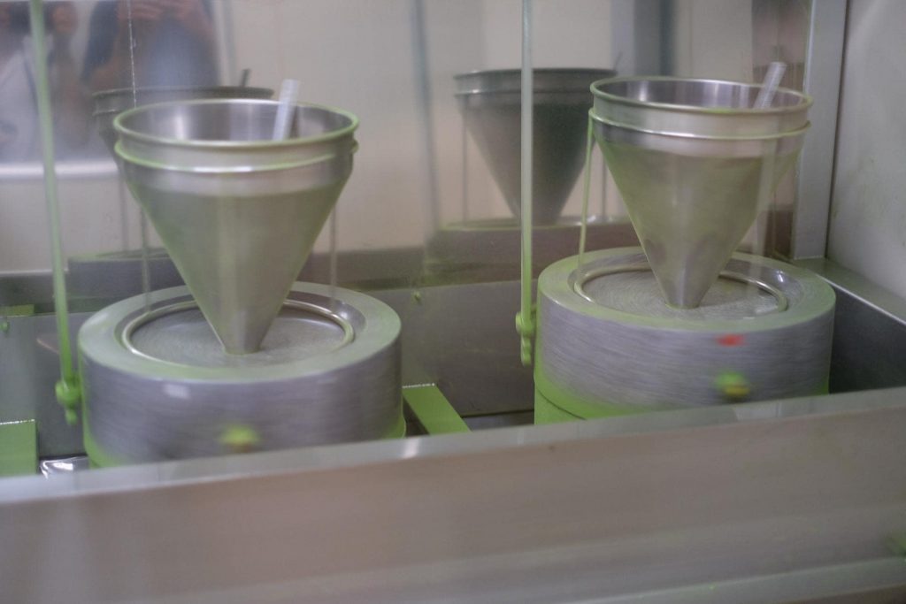 The traditional method for turning tea leaves into matcha tea powder is to grind the leaves in a stone mill. 